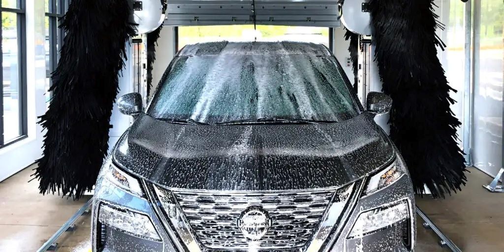 Modern touchless car wash system cleaning a vehicle without brushes or physical contact
